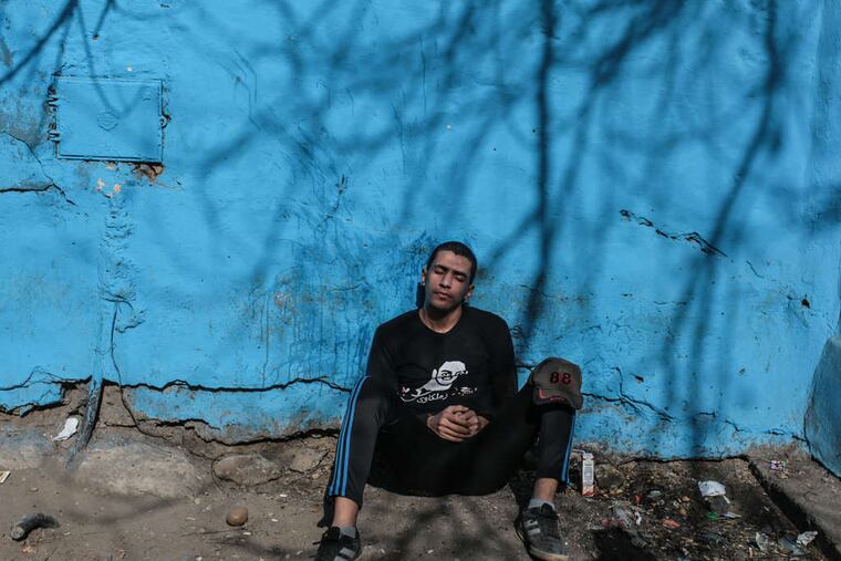A soccer fan mourns his friends who died in a stadium crush on Sunday in Cairo.