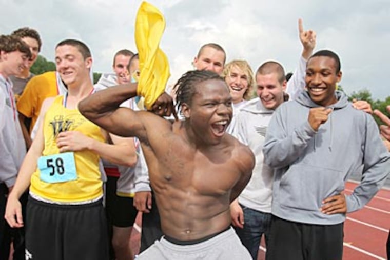 Rashaad Williams pulls off his shirt as members of the
Central Bucks West track team celebrate. (Charles Fox/Staff Photographer)