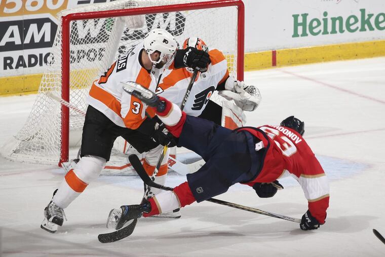Flyers defenseman Radko Gudas (3) upends Florida Panthers right wing Evgeni Dadonov (63) who was skating across the goal crease during the third period the Flyers’ 3-2 loss on Thursday.