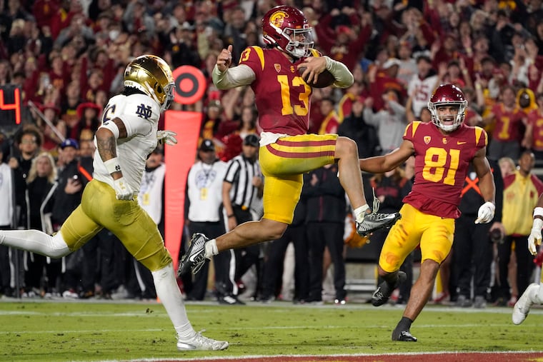 USC quarterback Caleb Williams jumps in for a touchdown against Notre Dame last season.