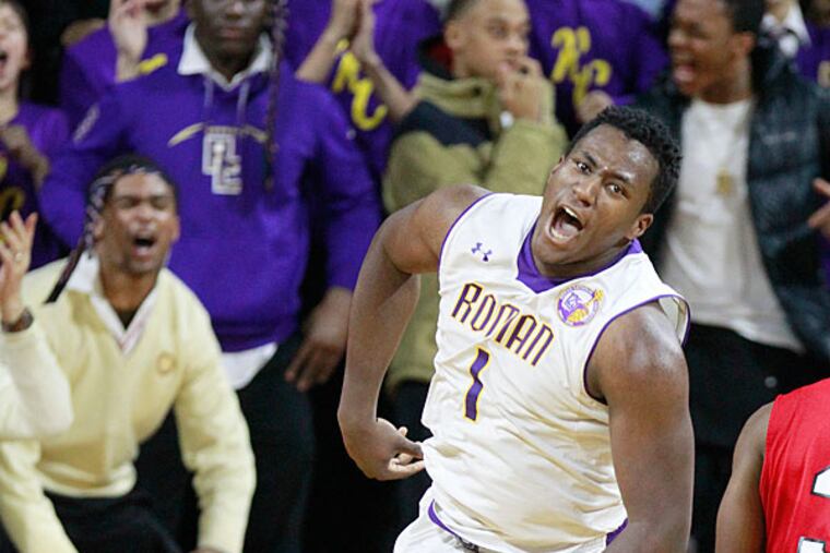 Manny Taylor of Roman Catholic celebrates a 4th quarter basket as the Roman student section also celebrates. Roman defeated Archbishop Carroll 61-58 in the Catholic League boys' basketball semifinal at the Palestra on Feb. 18, 2015. (Charles Fox/Staff Photographer)