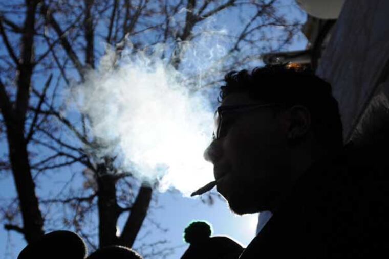 A man identifying himself as Wilfredo Gomez, 32, of north New Jersey, who claims he has a medical condition related to an accident, smokes marijuana in front of reporters in support of medical marijuana outside of the Greenleaf Compassion Center in Montclair, N.J., following a news conference Thursday, Dec. 6, 2012. Gomez is not a registered and approved patient and did not get his marijuana from the center. The establishment is New Jersey's first medical marijuana dispensary, and says it is serving only 20 clients per day at first, and only by appointment. (AP Photo/The Record of Bergen County, Mitsu Yasukawa) ONLINE OUT; MAGS OUT; TV OUT; INTERNET OUT; NO ARCHIVING; MANDATORY CREDIT