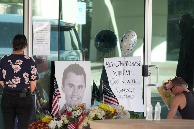 Well-wishers in Phoenix pay their respects at a makeshift memorial outside the national headquarters of Turning Point USA after the shooting death of Charlie Kirk, the cofounder and CEO of the organization on Wednesday.