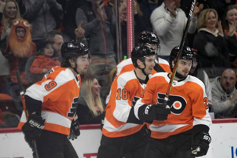 Flyers forward Scott Laughton (21) celebrates with his teammates after scoring in the first period of a game against the Winnipeg Jets at the Wells Fargo Center on Saturday, Feb. 22, 2020.