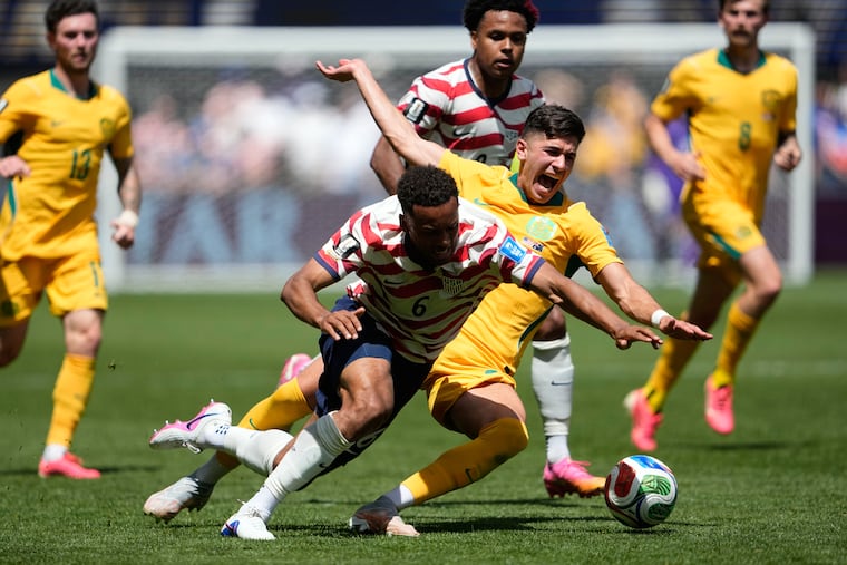 United States' Auston Trusty, left, and Australia's Cristian Volpato fall to the ground during the World Cup Group D soccer match between the United States and Australia in Seattle, Friday, June 19, 2026.