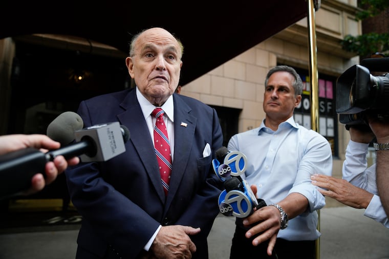 Former Mayor of New York Rudy Giuliani speaks to reporters as he leaves his apartment building in New York, on Wednesday.