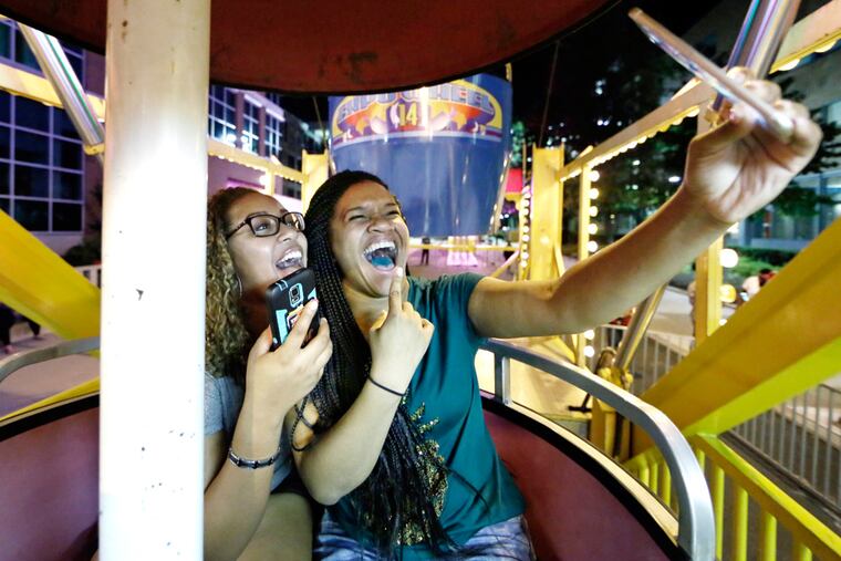 Temple junior Tyra Jennings of Brookdale Md (left) and senior Alaya White of Glenolden take a selfie on the ferris wheel at Temple University on Aug. 27, 2016.