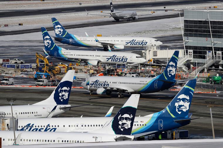 In this 2019 photo, Alaska Airlines planes are parked at a gate area at Seattle-Tacoma International Airport in Seattle. Alaska Airlines said over 300 employees among the company's workforce in Anchorage may lose their jobs on Oct. 1, 2020.