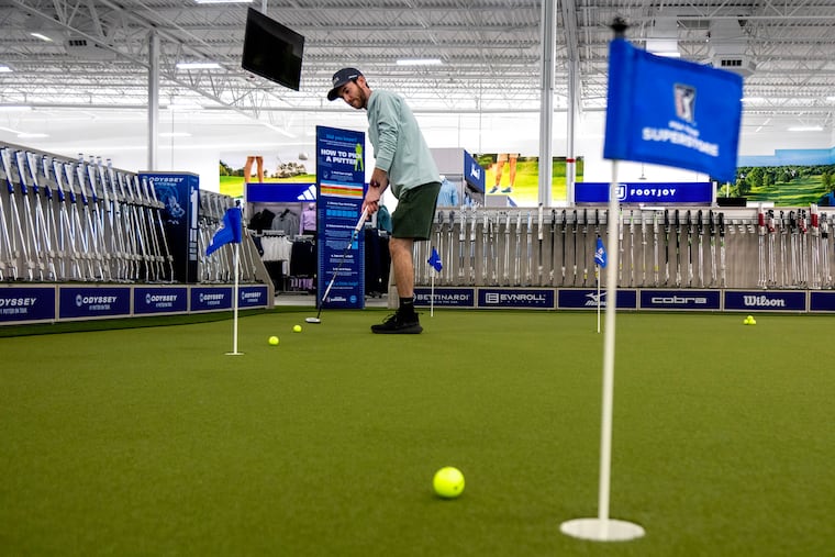 Store club fitter Jeff Eaton putts on the practice green in the PGA Tour Superstore in Cherry Hill on Tuesday The national chain golf retailer is opening its 80th store - the first in South Jersey - on Saturday in the Garden State Pavilions on Route 70.