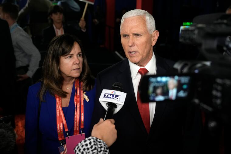 Former Vice President Mike Pence, joined by his wife, Karen, speaks with reporters Thursday after the first Republican presidential primary debate in Milwaukee.