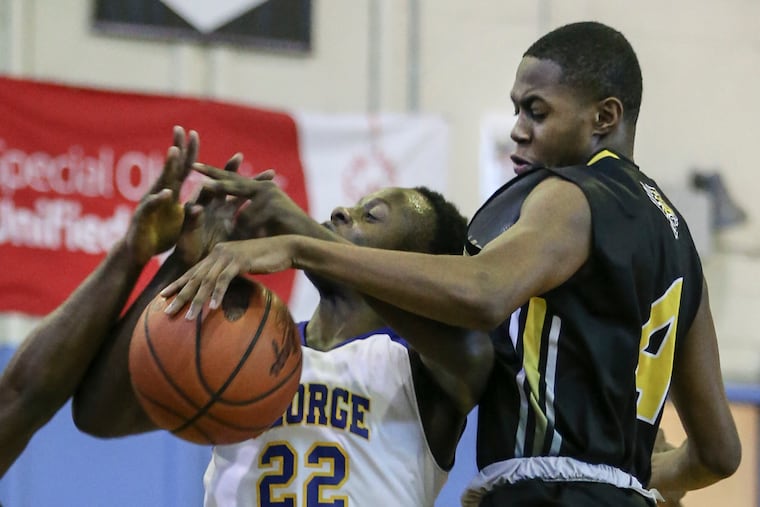 Kensington's Chris Small (right) battles with George Washington's Teyvon Hardy during the Public League basketball game Monday. Kensington won 69-61.