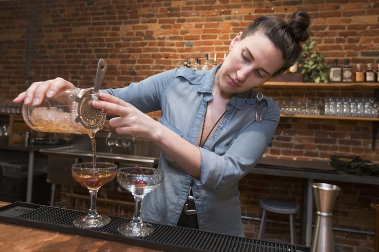 Jackie Nevin mixes up a pair of Damson Manhattans at the bar area at Art in the Age.