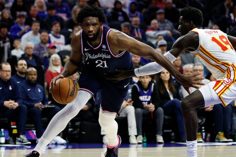 Sixers center Joel Embiid is guarded by Hawks forward Mouhamed Gueye in the second quarter Sunday.