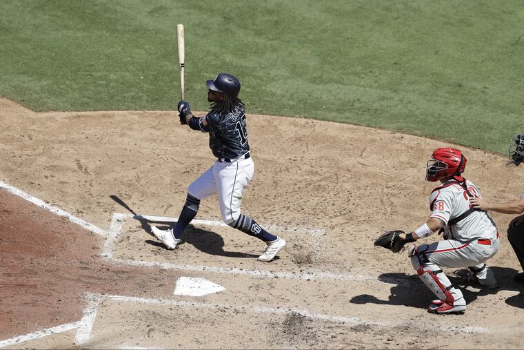 San Diego's Freddy Galvis watches his grand slam leave the park during the third inning against the Phillies.