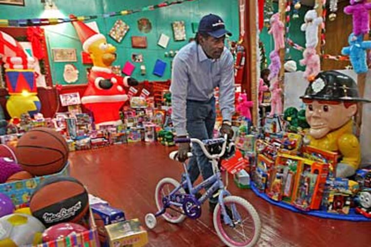 Rev. Al Stewart wheels a donated bike. The supply is not nearly enough to fill need. ( Michael Bryant / Staff Photographer)