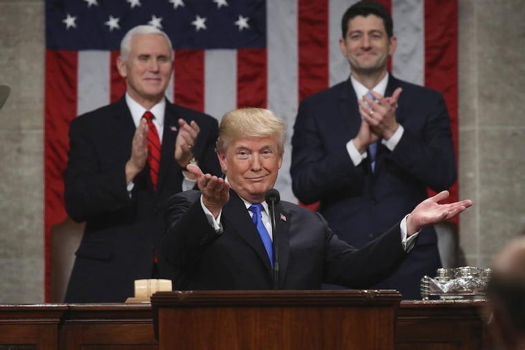 President Donald Trump gestures as he delivers his first State of the Union address in the House chamber of the U.S. Capitol to a joint session of Congress as Vice President Mike Pence and House Speaker Paul Ryan applaud.