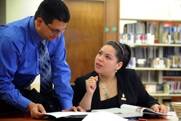 Crystal Rosa Pagan-Perez, 21, a second-year psychology major at Camden County College, talks with Dr. Michael Colbert, chair of the psychology department, on Jan. 21, 2015. Pagan-Perez is part of the NJ STARS program. ( CLEM MURRAY / Staff Photographer )