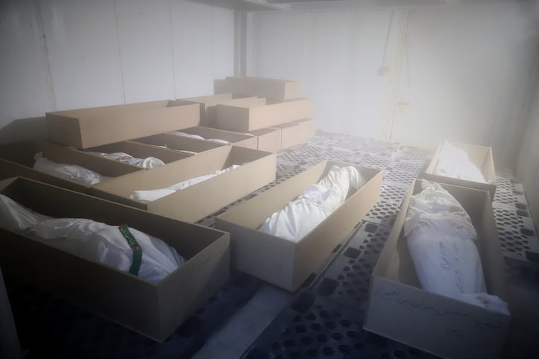 Coffins holding the bodies of mostly children sit in a room as they are prepared for the funeral of those killed in what Iranian officials said was an Israeli-U.S. strike on Feb. 28 at a girls' elementary school in Minab, Iran, in March.