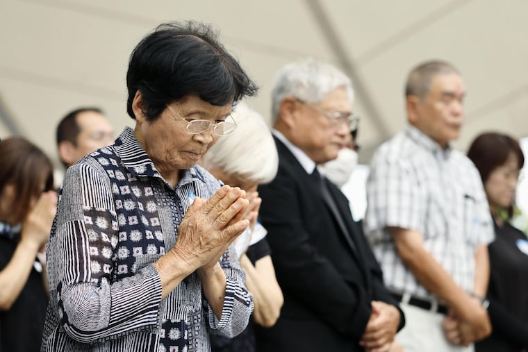 People observe a minute of silence during a ceremony to mark the 81st anniversary of the U.S. atomic bombing at the Peace Park in Nagasaki, southern Japan Sunday, Aug. 9, 2026.