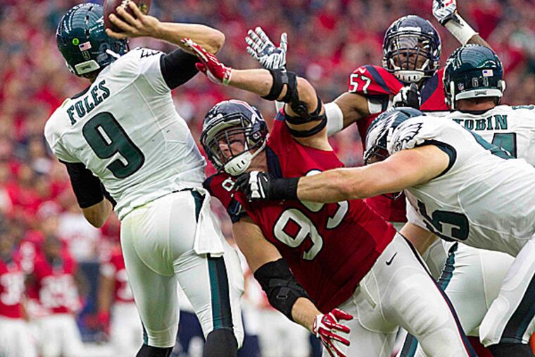 Texans defensive end J.J. Watt pressures Eagles quarterback Nick Foles. (Jason Fochtman/The Courier/AP)