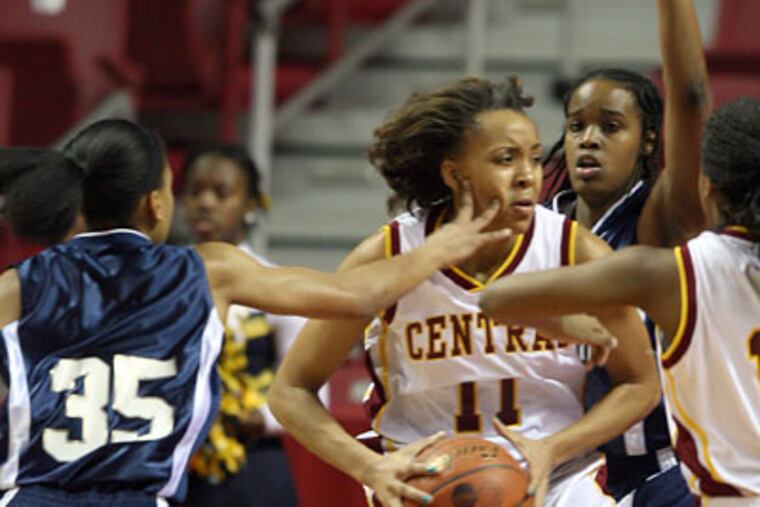 Central High's Janaa Pickard gets a hand in the face from Prep Charter's Bria Young (left) as Lashsay Banks (right) defends in the first quarter of the Public League girls basketball championship game at the Liacouras Center on Friday. (Yong Kim / Staff Photographer)