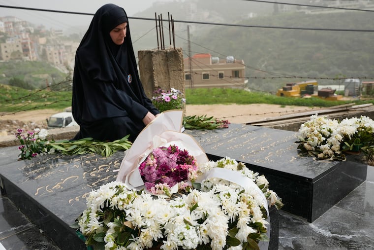 Malak Meslmani, the mother of Jawad Younes, 11, who was killed on March 27, 2026 in an Israeli airstrike, visits her son's grave in Saksakieh village, south Lebanon, Friday, April 3, 2026.