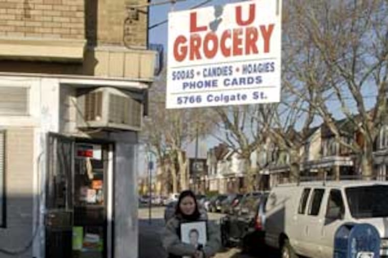 Jiaxhing's widow leaves the Lu family store today carrying her slain husband's portrait.