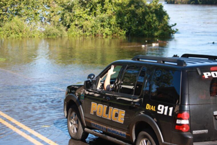 A stretch of River Road in Yardley Borough was flooded on Saturday morning. Police closed the road around 6 a.m. after the Delaware River crest began to flood the roadway. (Larry King / Staff)