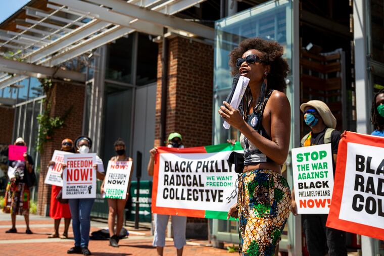 Yahné Ndgo, Chief Visionary Officer with Deep Blu Womyn Company, speaks to press and people in the community about the 13 demands for the city to defund police and abolish “carceral systems targeting black communities,” at the President’s House Slavery Memorial on Friday.