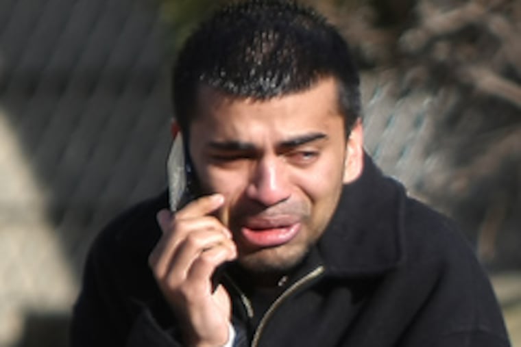 A tearful Nijith Kurian outside the Clifton church where three were shot, one fatally.