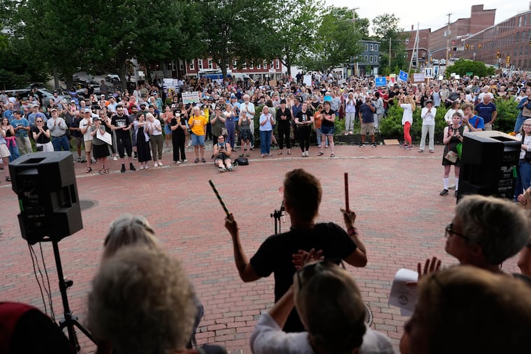 Attendees stand during a vigil after a man was shot and killed by U.S. Immigration and Customs Enforcement on Monday, July 13, 2026, in Biddeford, Maine.