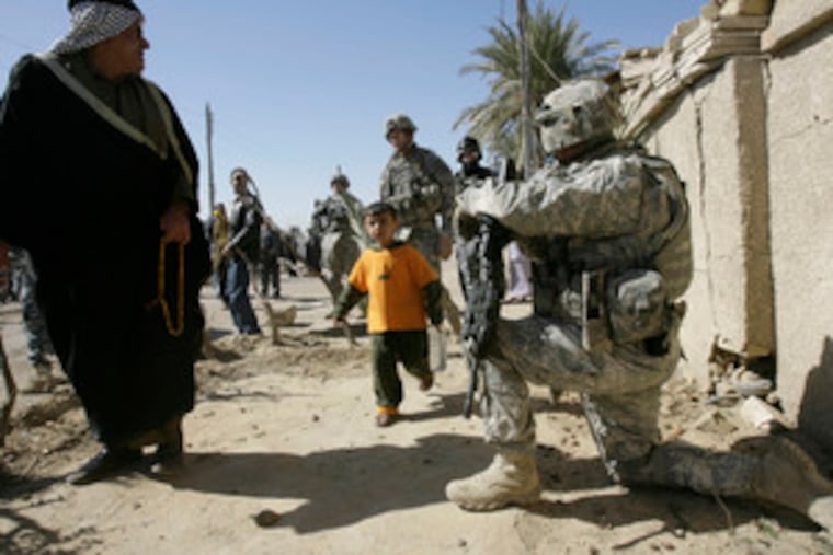 U.S. soldiers are on hand as residents return to the al-Amil neighborhood in Baghdad. They came back yesterday after fleeing sectarian violence in 2006. An Army official said that 78 percent of the districts are free of organized extremist activity.