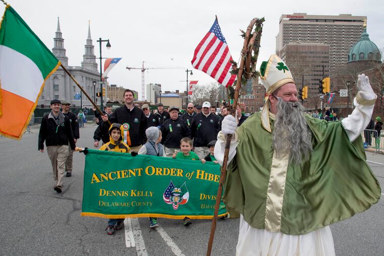 John Cooke, dressed at St. Patrick, leads members of the Ancient Order of Hibernians Div. 1 Dennis Kelly out of Havertown around Logan Circle and up the Ben Franklin Parkway during Philadelphia's annual St. Patrick's Day Parade March 13, 2016. CLEM MURRAY / Staff Photographer