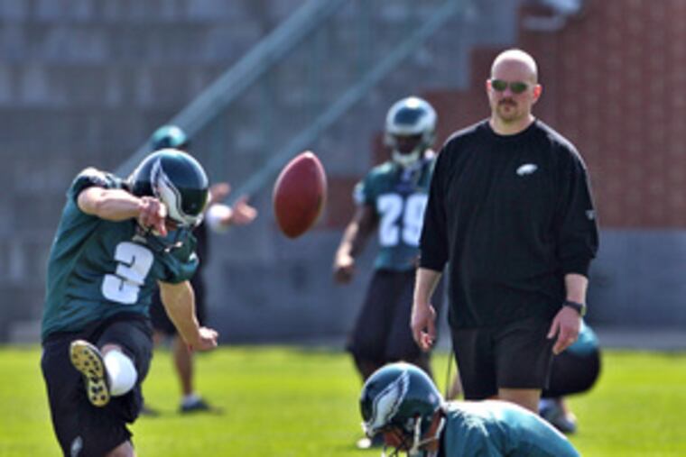 Rory Segrest watches kicker E.J. Cochrane and holder Saverio Rocca.