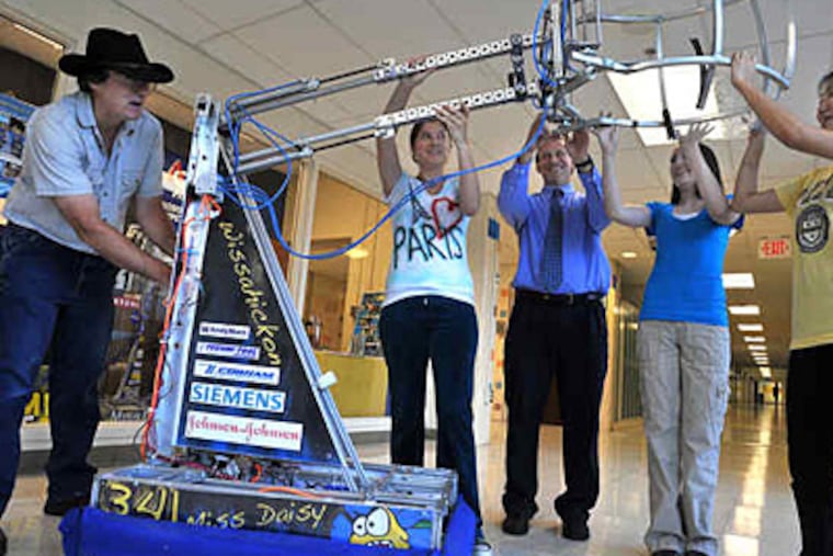 Flanking their robot, Miss Daisy, at Wissahickon High School are (from left) assistant coach Matthew Trageser, Lily Coryell, 17, coach Alan Ostrow, Gina Triolo, 17, and Vivian Park, 18. The three students are seniors. (Sharon Gekoski-Kimmel / Staff)