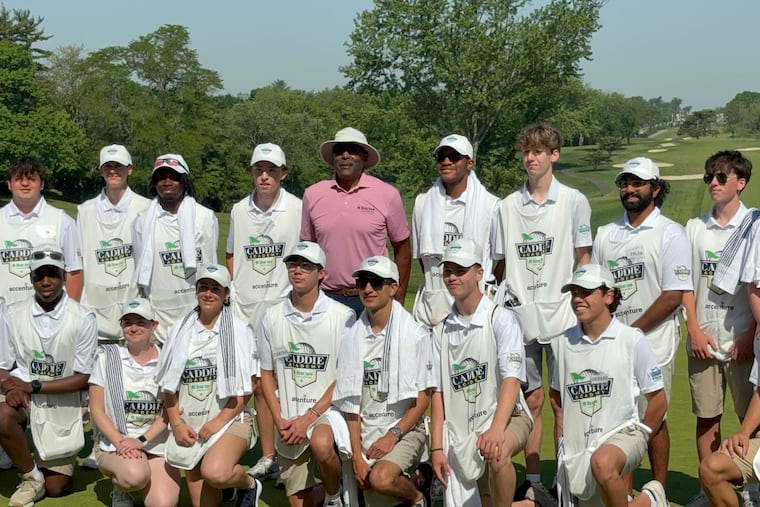 Mike Quick poses with the caddies of First Tee at the 11th annual Mike Quick Celebrity Golf Invitational.