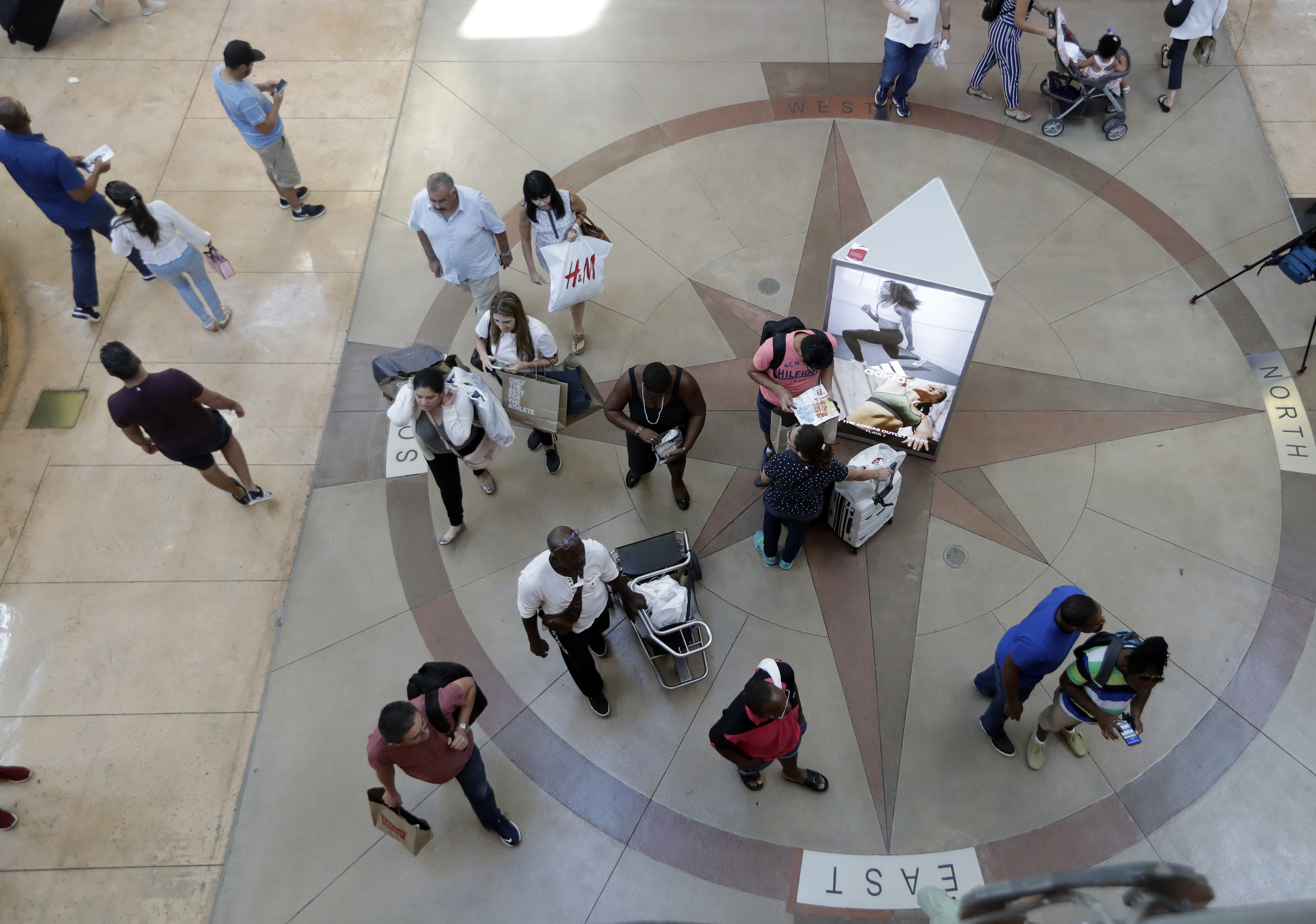 FILE photo shows shoppers walking through Dolphin Mall on Black Friday in Miami. (AP Photo/Lynne Sladky, File)