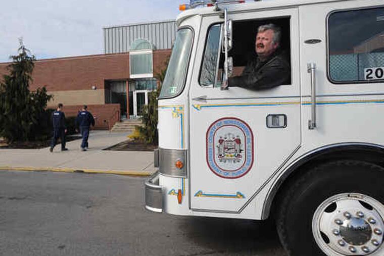 J.C. "Sarge" Bohleman picks up a fire truck he bought from Montco. His company supplies vehicles to movie sets.