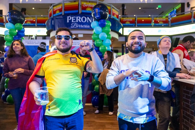 Northeast Philly's Wilson Velez, 36, (left) and Center City's Edwin Martinez, 25, watch the draw for the 2026 FIFA World Cup at Stateside Live!
