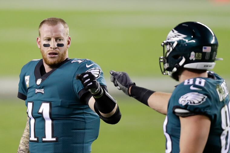 Eagles quarterback Carson Wentz (left) made it clear in a recent podcast interview that he doesn't view football through the same prism as the team's fans.