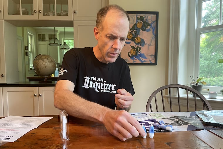 Inquirer staff writer Tom Avril grabs a spring-loaded lancet to prick his finger, so he can send in a blood sample for coronavirus antibody testing at the National Institutes of Health.