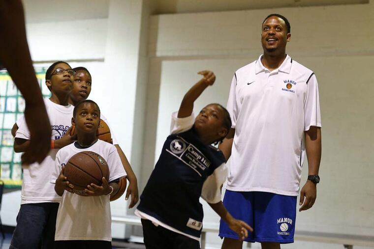 David Ellerbee, right, gives instructions during the Leon H. Sullivan Community Hoops and Conference at the Zion Baptist Church in Philadelphia, PA on June 23, 2017. It is a 3-day sports conference featuring games and educational workshops.