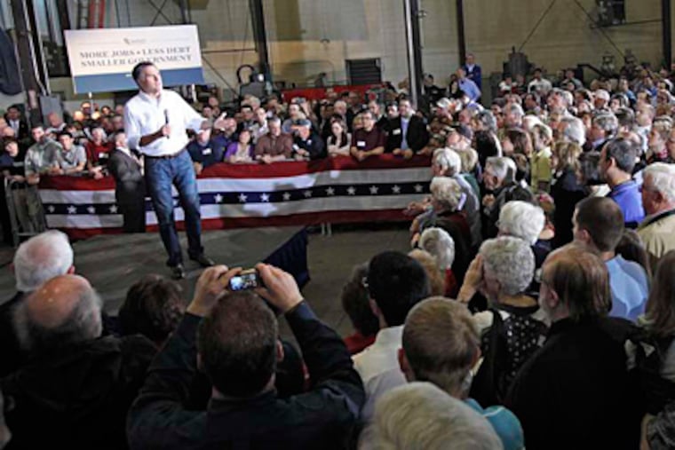 Republican presidential candidate Mitt Romney talks to supporters gathered at the Iron Shop in Broomall, a family-owned maker of spiral staircases. DAVID M WARREN / Staff Photographer