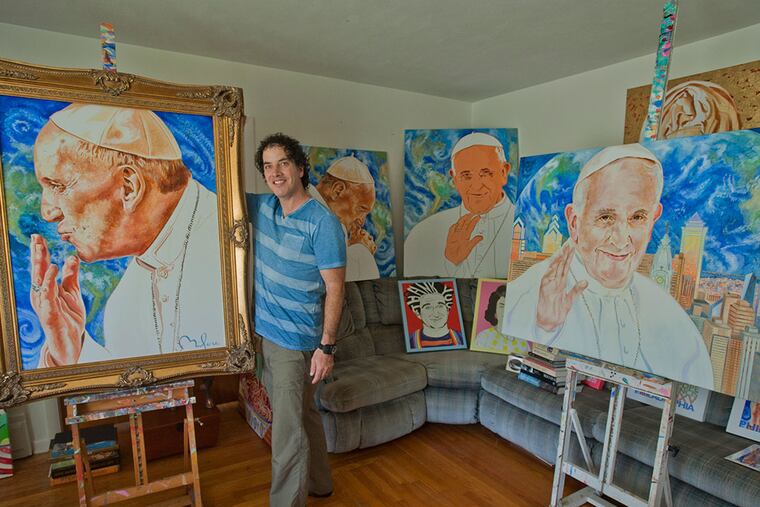 Artist Perry Milou with a collection of paintings he did of Pope Francis called "The Faces of Francis." (Avi Steinhardt/For The Inquirer)