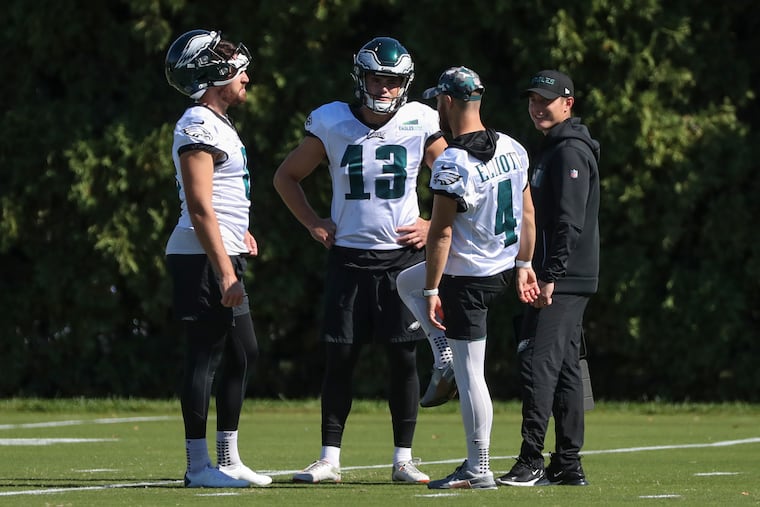 Recently signed Eagles kicker Cameron Dicker (13) speaks with Jake Elliott (4) and Arryn Siposs during practice at the NovaCare Complex on Thursday.