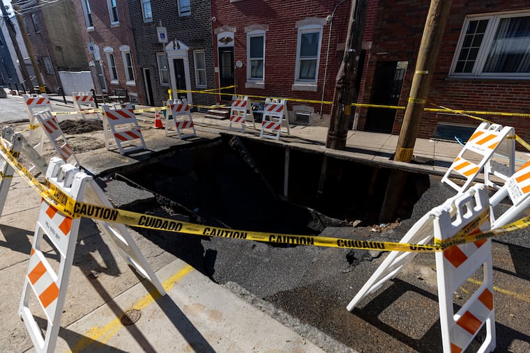 Part of Birch Street in Port Richmond collapsed on Tuesday. On Wednesday, the street remained blocked off and the hole surrounded by barriers wrapped in caution tape.