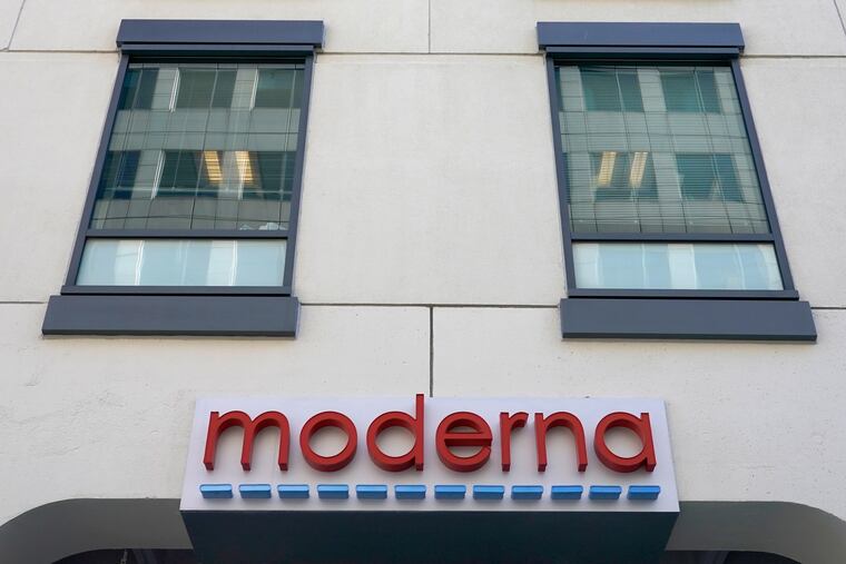 In this Dec. 15, 2020 photo, a sign for Moderna hangs on its headquarters in Cambridge, Mass.