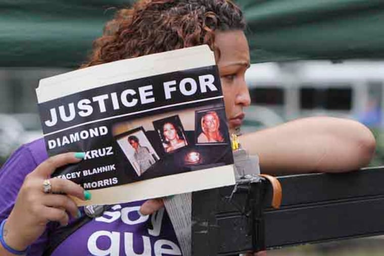 Naiymah Sanchez holds a sign in support of her friend during a vigil in LOVE Park, for "Diamond," the alleged transgender prostitute whose dismembered body was found in Strawberry Mansion. Tuesday, July 23, 2013. ( Steven M. Falk / Staff Photographer )