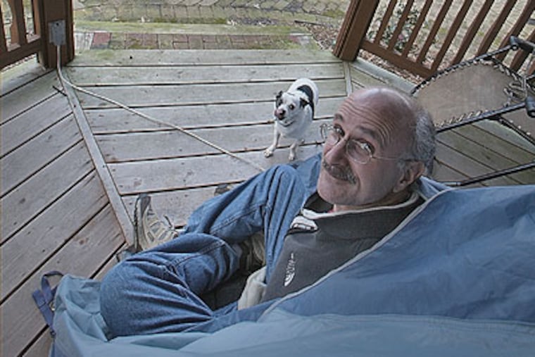 Dr. Gerald Feigin, Camden and Gloucester County medical examiner, had been living in a tent in his backyard because he becomes violently ill inside his home. (David M Warren / Staff Photographer)