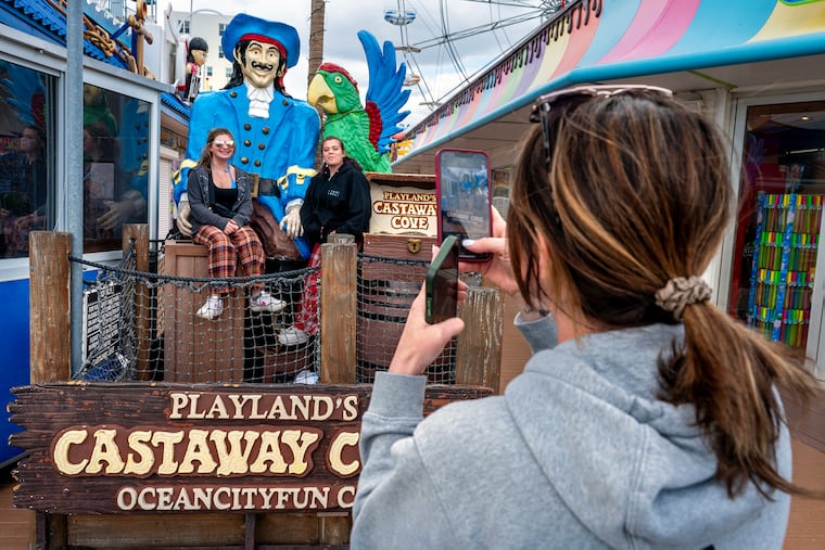 Lauren Webb, of Delaware County, recreates a childhood photo with her now 13 year-old daughter Cameron (left) with her friend Charlotte Sutch, 14, outside the still-closed Playland's Castaway Cove Apr. 16, 2025. (The original photo was made with Cameron’s older brother Chase.) Opening soon, it is the only amusement park left on the Ocean City Boardwalk after last year’s closure of Wonderland Pier.
